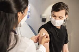 Can you withhold sick pay for unvaccinated workers?